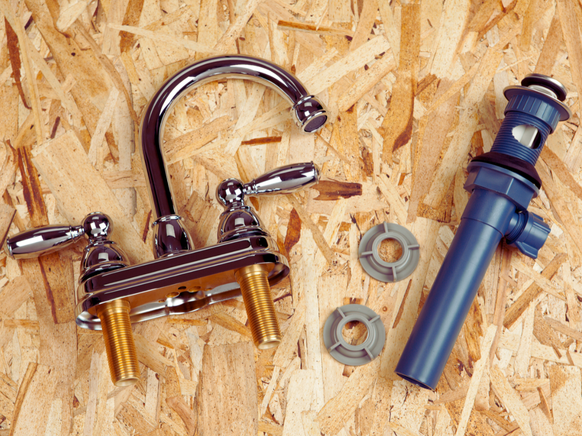 Faucet components laying on table