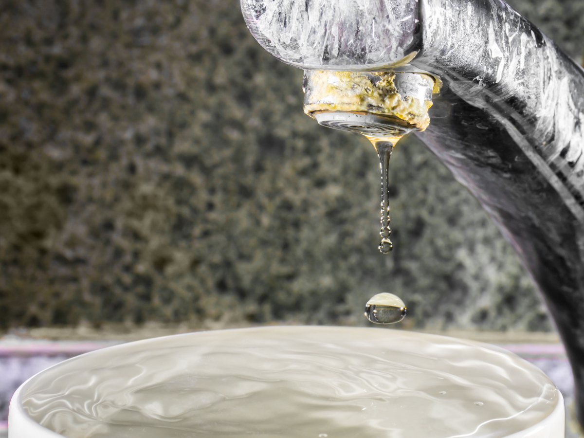 White limescale buildup on bathroom faucet 