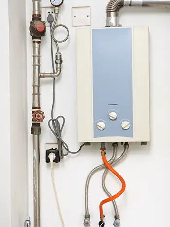 An electric tankless water heater installed in the garage of a Niceville FL home