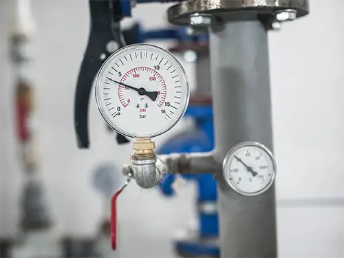 Closeup of a water pressure regulator gauge installed in a home in Niceville FL